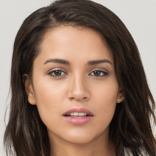 Joyful white young-adult female with long  brown hair and brown eyes