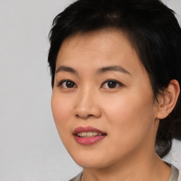 Joyful asian young-adult female with short  black hair and brown eyes