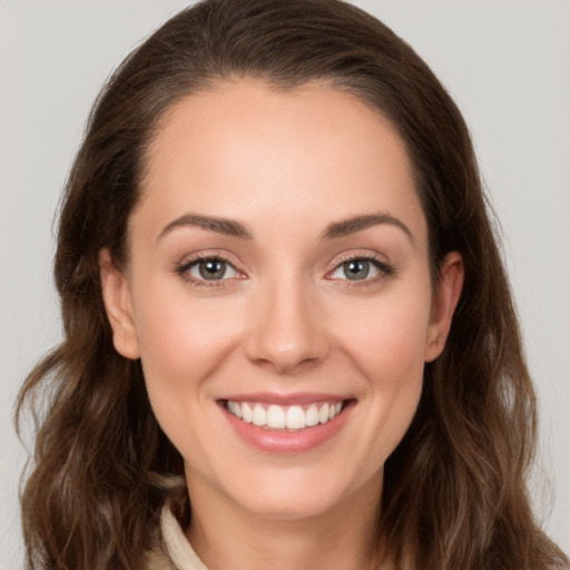 Joyful white young-adult female with long  brown hair and brown eyes