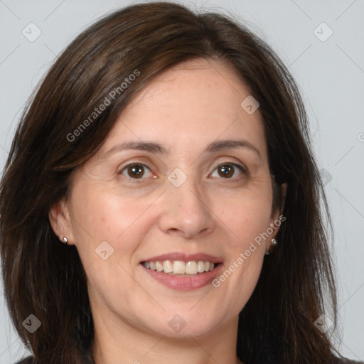 Joyful white adult female with long  brown hair and brown eyes