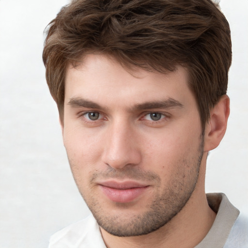 Joyful white young-adult male with short  brown hair and grey eyes