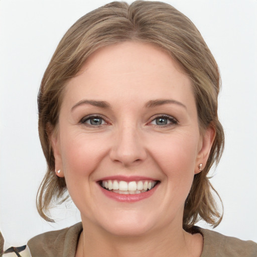 Joyful white young-adult female with medium  brown hair and grey eyes