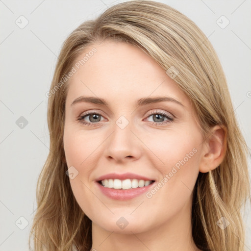 Joyful white young-adult female with long  brown hair and blue eyes