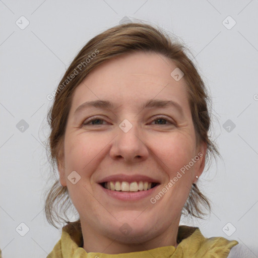 Joyful white young-adult female with medium  brown hair and blue eyes