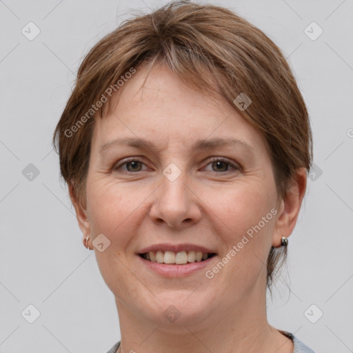 Joyful white adult female with medium  brown hair and grey eyes