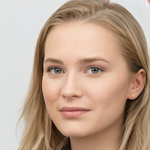 Joyful white young-adult female with long  brown hair and blue eyes