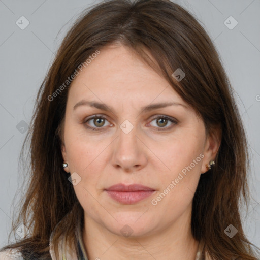 Joyful white adult female with long  brown hair and brown eyes