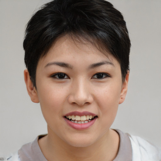 Joyful asian young-adult female with short  brown hair and brown eyes