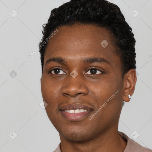 Joyful black young-adult male with short  black hair and brown eyes