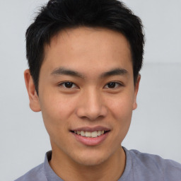 Joyful asian young-adult male with short  brown hair and brown eyes