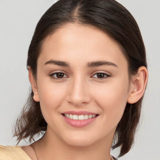 Joyful white young-adult female with medium  brown hair and brown eyes