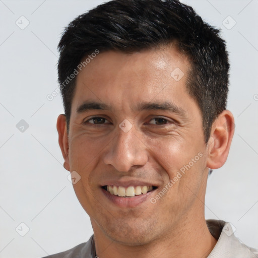 Joyful white adult male with short  black hair and brown eyes