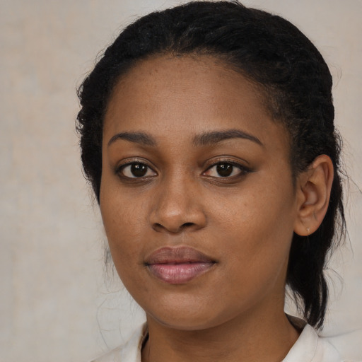 Joyful black young-adult female with long  brown hair and brown eyes