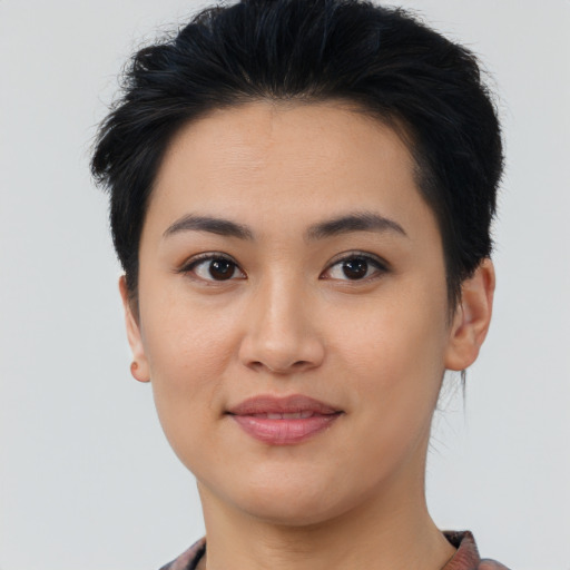 Joyful asian young-adult female with short  brown hair and brown eyes