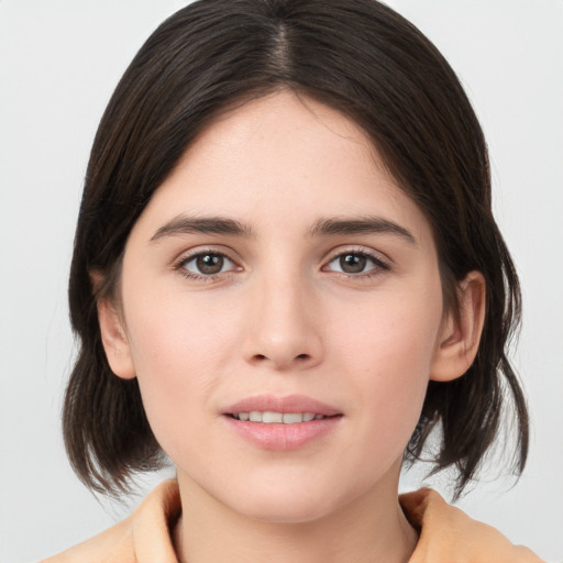 Joyful white young-adult female with medium  brown hair and brown eyes