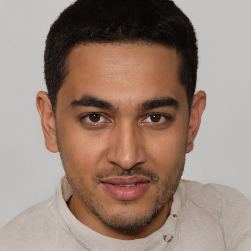Joyful latino young-adult male with short  brown hair and brown eyes