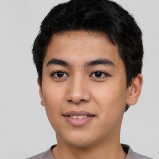 Joyful asian young-adult male with short  black hair and brown eyes
