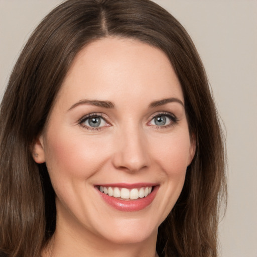 Joyful white young-adult female with medium  brown hair and green eyes