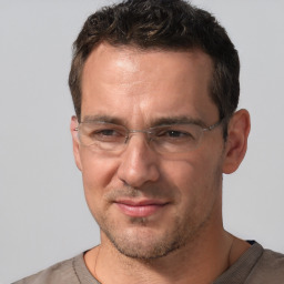 Joyful white adult male with short  brown hair and brown eyes
