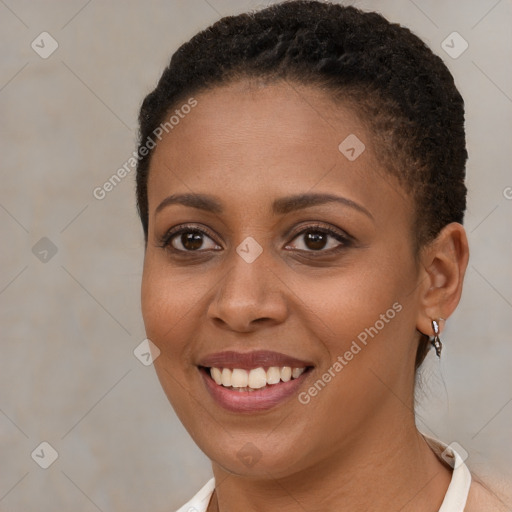 Joyful black young-adult female with short  brown hair and brown eyes