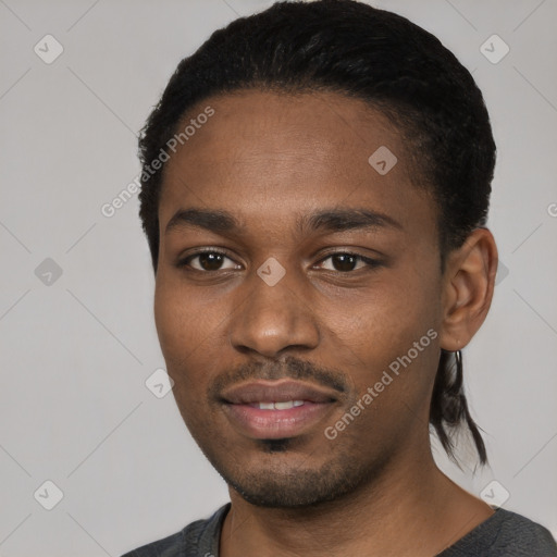 Joyful black young-adult male with short  black hair and brown eyes