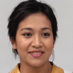 Joyful asian young-adult female with medium  brown hair and brown eyes