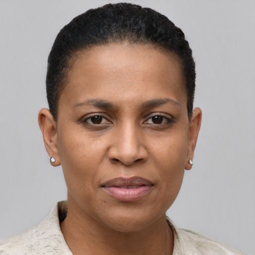 Joyful black young-adult female with short  brown hair and brown eyes