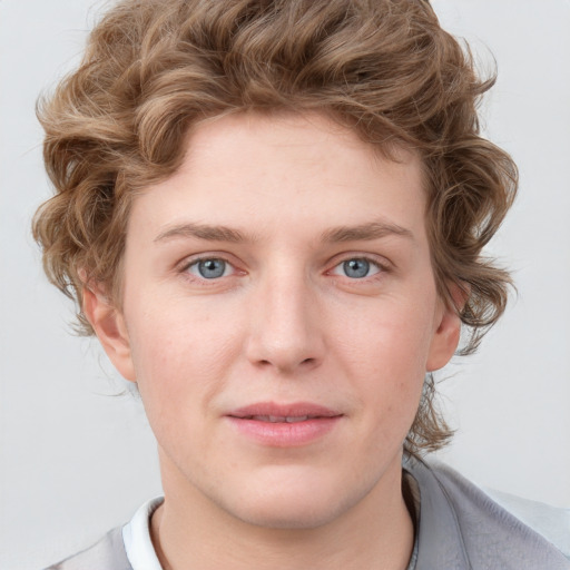 Joyful white young-adult male with short  brown hair and blue eyes