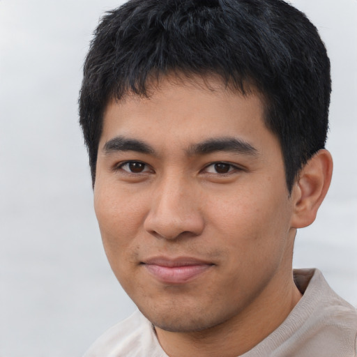 Joyful asian young-adult male with short  black hair and brown eyes