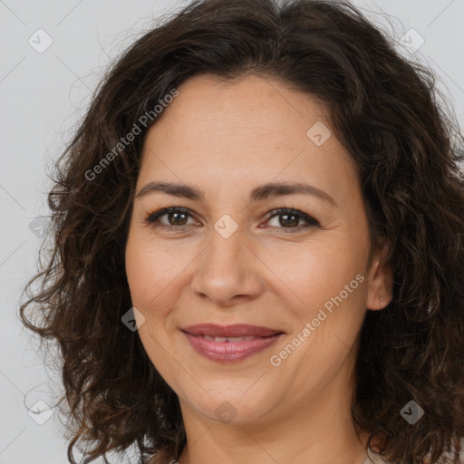 Joyful white adult female with long  brown hair and brown eyes