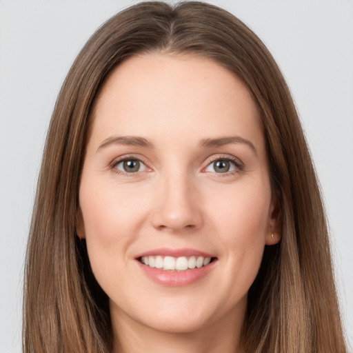 Joyful white young-adult female with long  brown hair and brown eyes