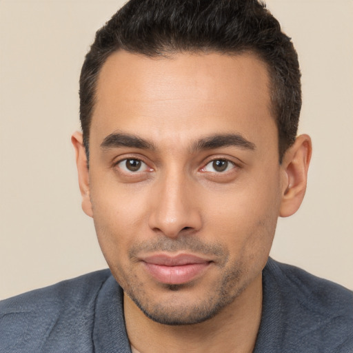 Joyful white young-adult male with short  black hair and brown eyes