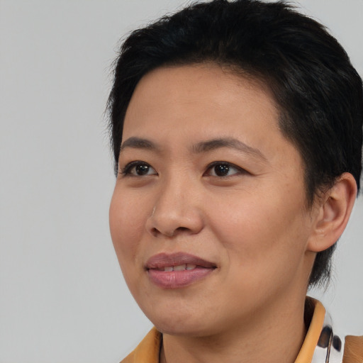 Joyful asian young-adult female with short  black hair and brown eyes