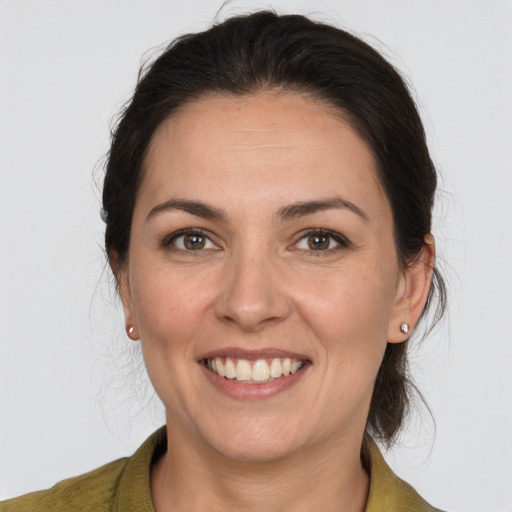 Joyful white young-adult female with medium  brown hair and brown eyes