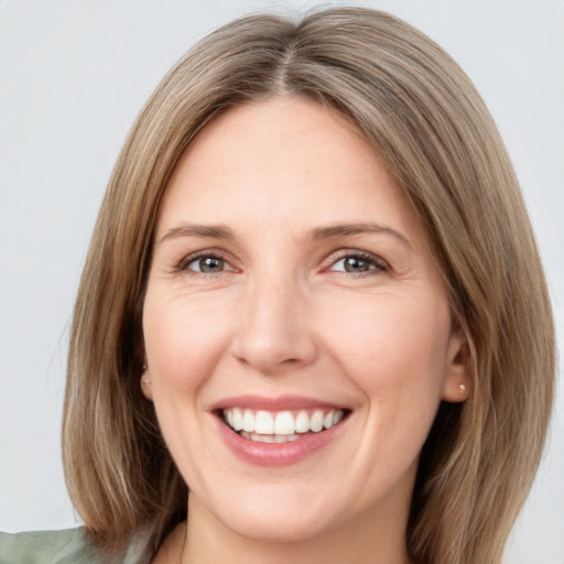 Joyful white adult female with medium  brown hair and brown eyes