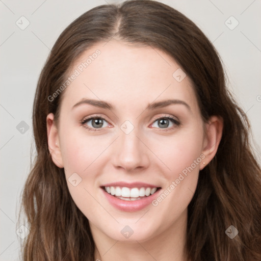 Joyful white young-adult female with long  brown hair and blue eyes