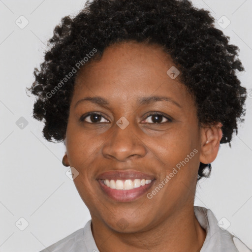 Joyful black adult female with short  brown hair and brown eyes