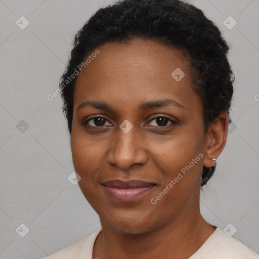 Joyful black young-adult female with short  brown hair and brown eyes