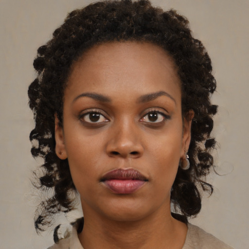 Neutral black young-adult female with medium  brown hair and brown eyes