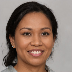 Joyful latino young-adult female with medium  brown hair and brown eyes