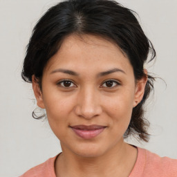 Joyful latino young-adult female with medium  brown hair and brown eyes