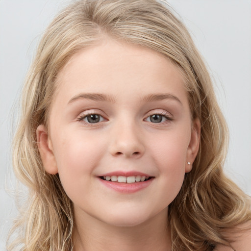 Joyful white child female with long  brown hair and blue eyes