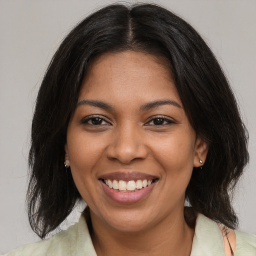 Joyful black young-adult female with medium  brown hair and brown eyes