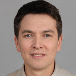 Joyful white adult male with short  brown hair and grey eyes