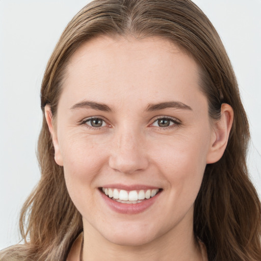 Joyful white young-adult female with long  brown hair and blue eyes