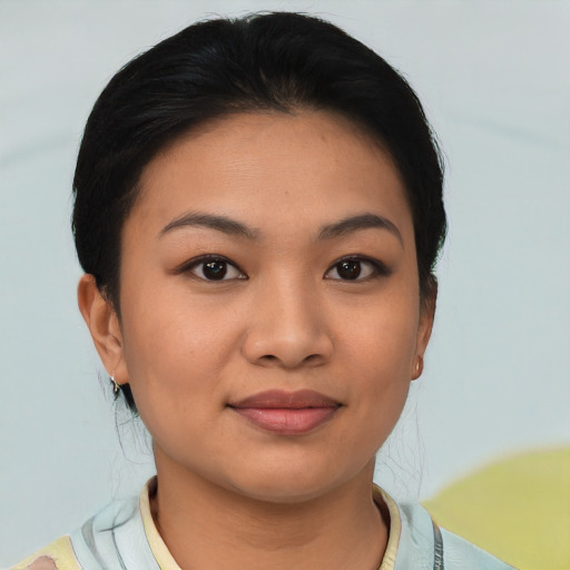 Joyful latino young-adult female with short  black hair and brown eyes