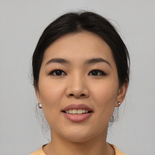 Joyful asian young-adult female with medium  black hair and brown eyes
