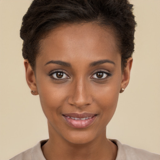 Joyful black young-adult female with short  brown hair and brown eyes