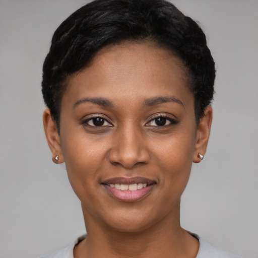 Joyful black young-adult female with short  black hair and brown eyes