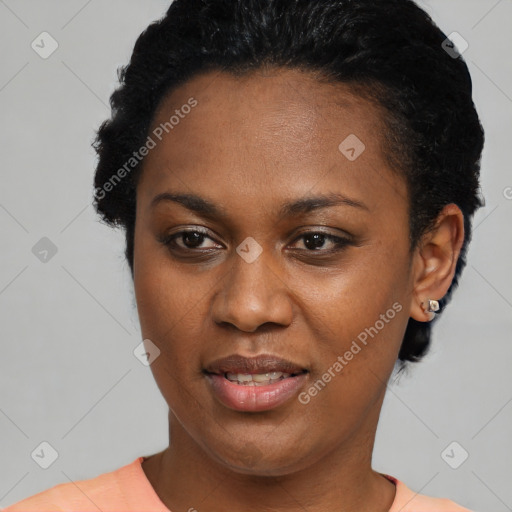 Joyful black young-adult female with short  black hair and brown eyes